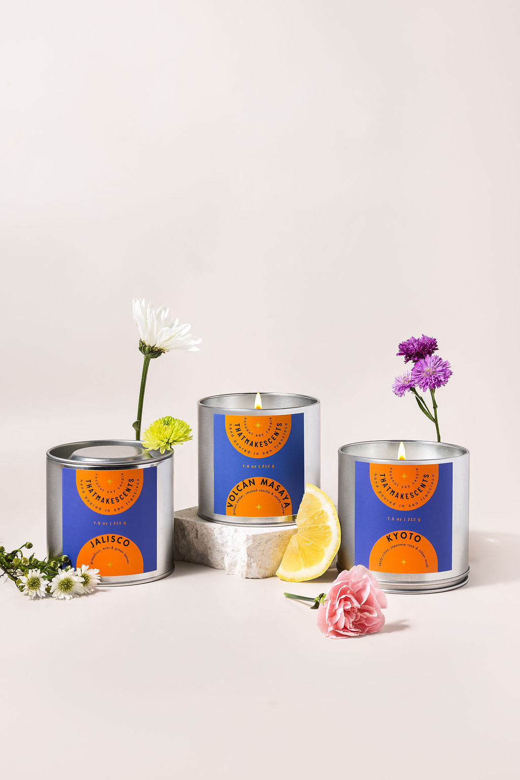 a group of candles with flowers and lemons